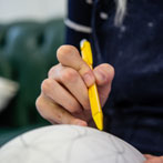 Rhian Malin decorating a mandala bottle in her workshop 2019